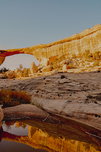 Desert sandstone arch with water in front.  Desert sandstone arch with water in front.